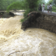 Residents stand next to a road which is partially washed away by flood water after Typhoon Usagi hit Quanzhou county, Guangxi Zhuang Autonomous Region September 24, 2013. At least 25 people have been killed since typhoon Usagi made landfall in south China's Guangdong Province on Sunday evening, Xinhua News Agency reported. REUTERS/China Daily